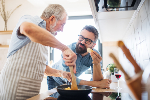 Father and son cooking breakfast together