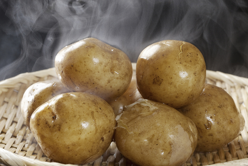 Freshly steamed potatoes with steam rising off