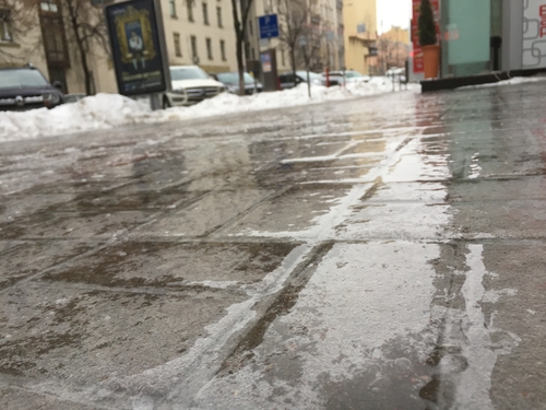 Hard to see ice on a brick pavement