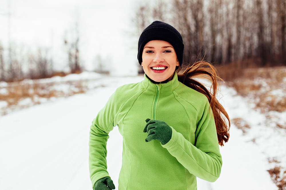 Woman jogging in a park in the snow