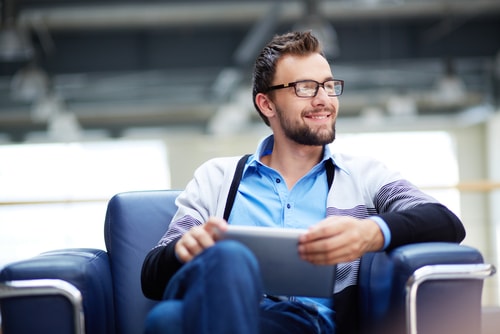 Casual businessman smiling while doing work