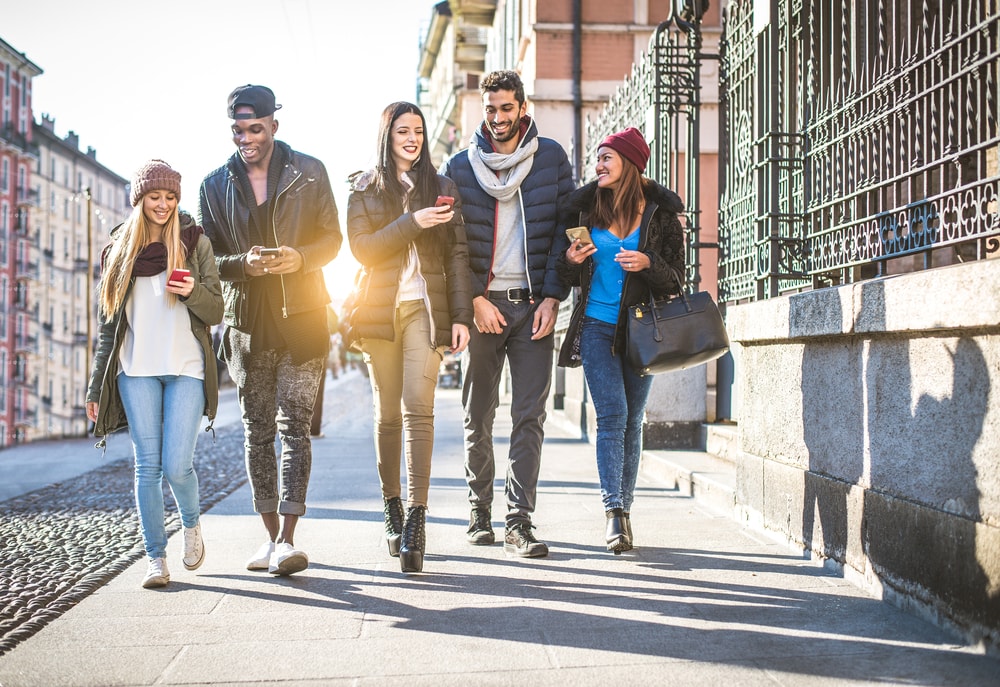 Multiracial friends walking down a city street