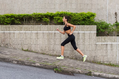Sporty woman jogging uphill