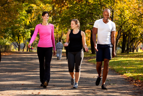3 people cooling down after a run or walk in the park