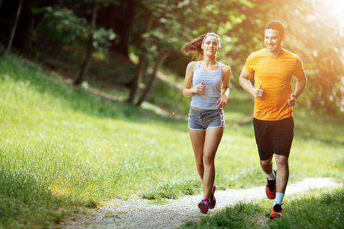 Couple jogging on a park footpath