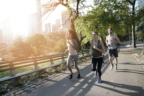 3 people jogging on an urban park path