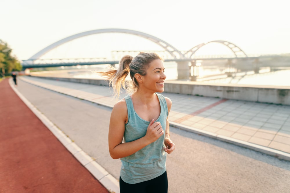 Woman fitness walking in morning by river