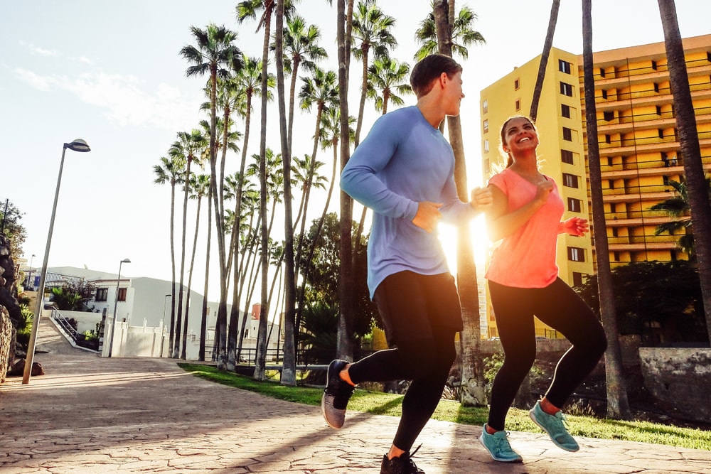 Man and woman jogging in city in morning