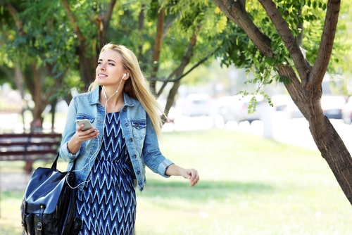 Walking in park listening to headphones