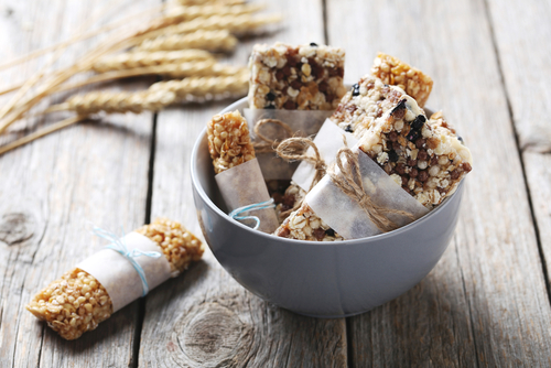 Granola bars wrapped up in a bowl on a table