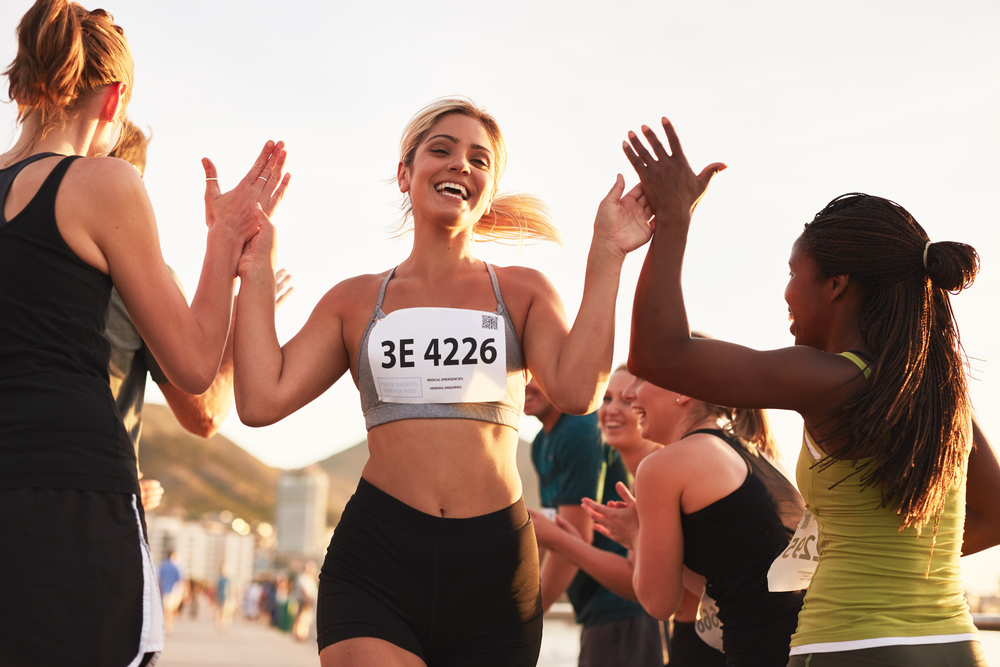 Woman finishing a running race with friends