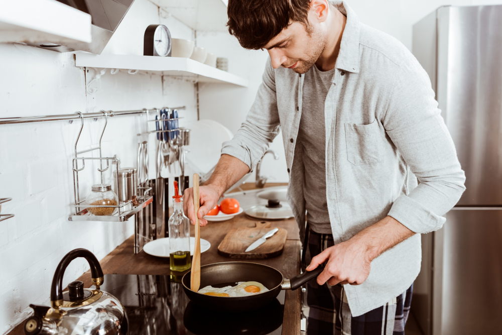 Man cooking eggs for breakfast