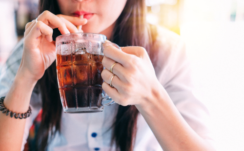 Woman drinking an unhealthy soda
