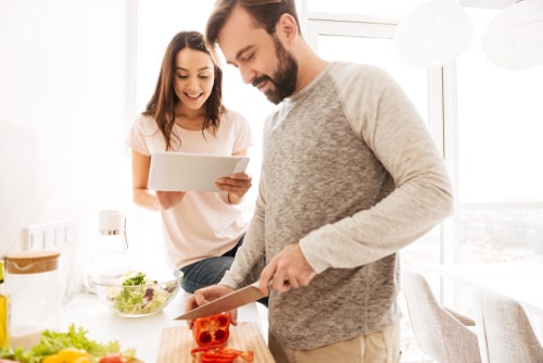 Man and woman preparing healthy meals at home