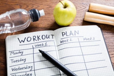Workout plan in diary fitness planning concept