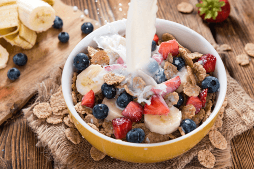 Healthy bran flakes cereal with fresh fruit and milk