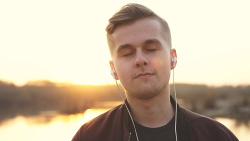 Man listening to headphones and relaxing