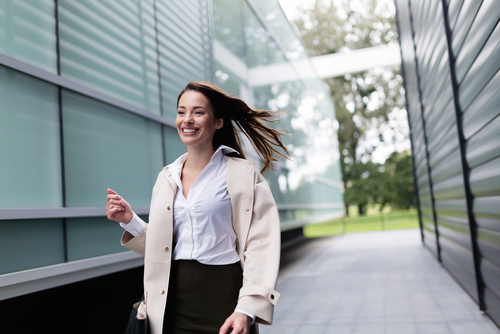 Businesswoman walking between buildings