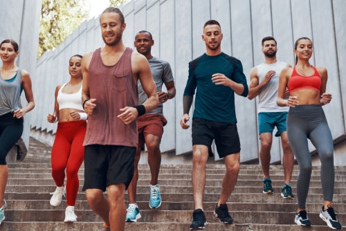 Group of people walking stairs together for fitness