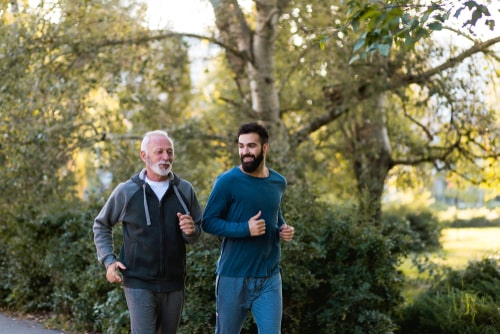Father and son fitness walking in park