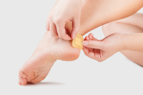 Putting bandage on blister