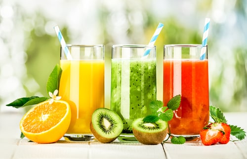 Colorful fruit and fruit juices in glasses
