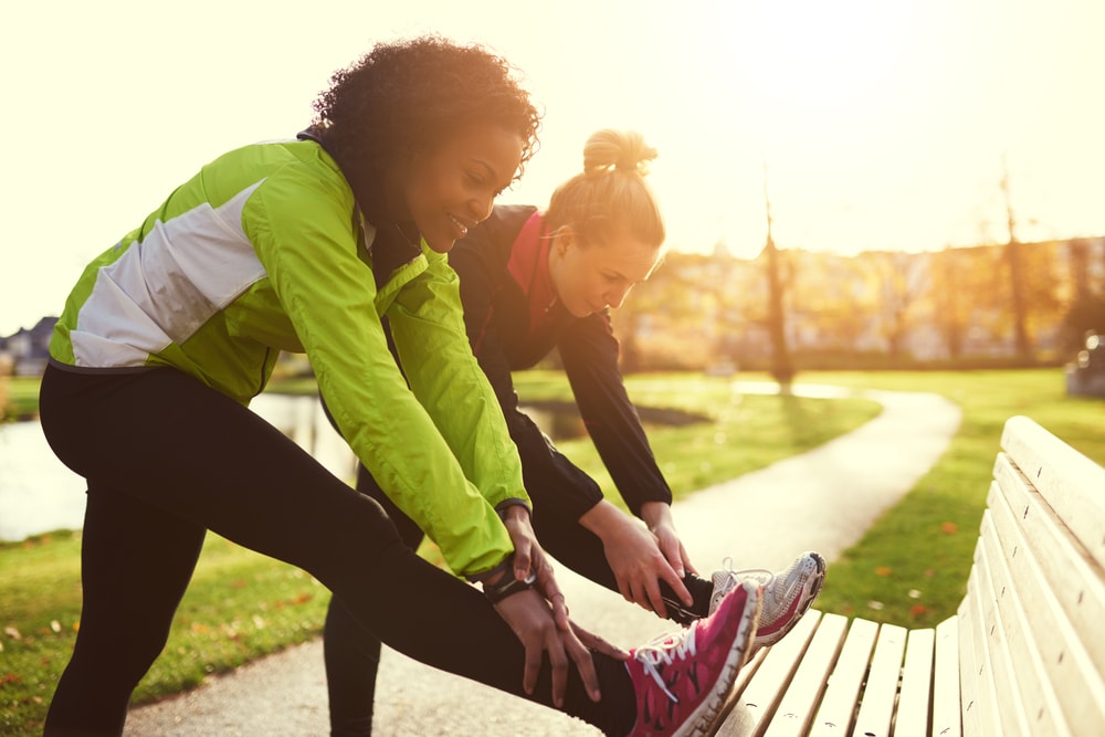 Women stretching before a daily park fitness walk