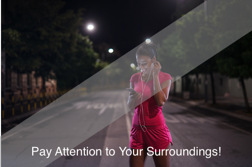 Woman listening to headphones while walking at night