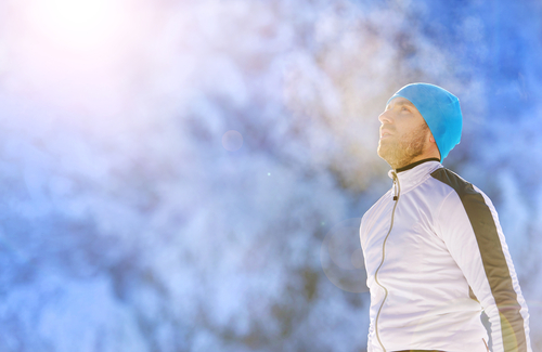 Man resting after jog in the winter snow