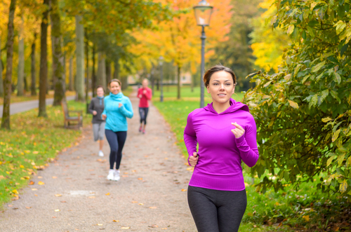 Women power walking in the park for fitness