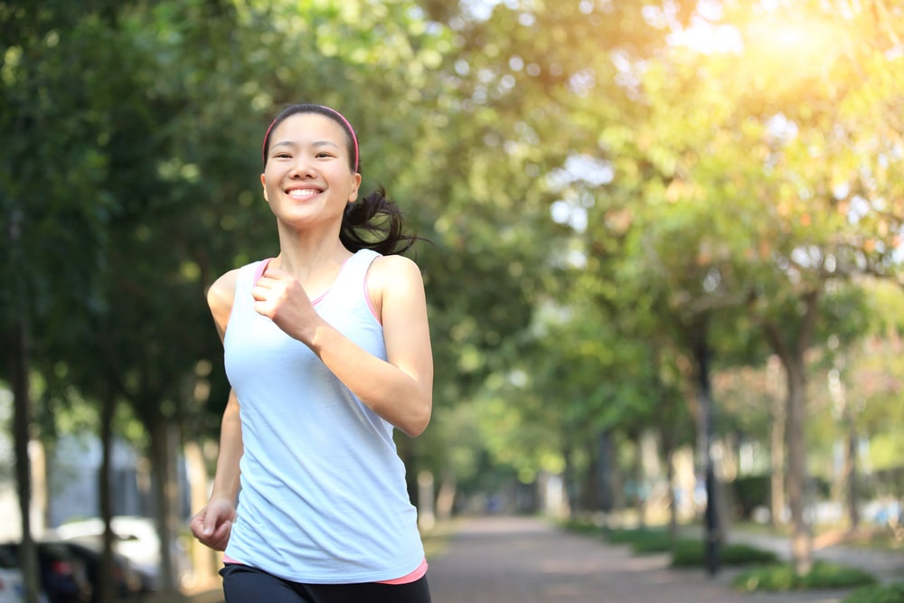 Smiling sporty woman morning walking in a park