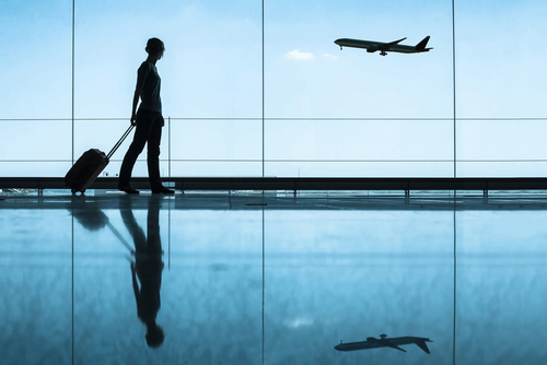 Woman walking with suitcase in an airport
