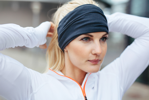 Woman tying hair ready for a walk or run