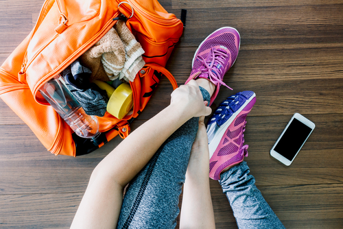 Woman putting on shoes to go for a jog