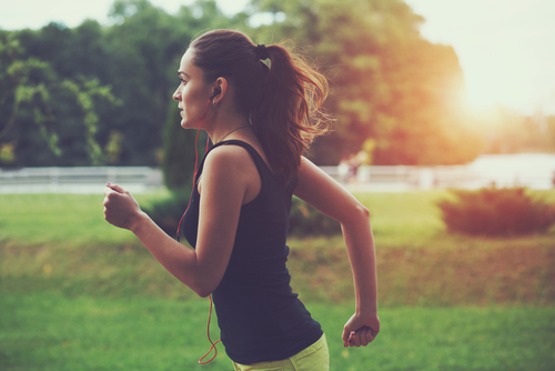 Woman jogging in park on a summer morning