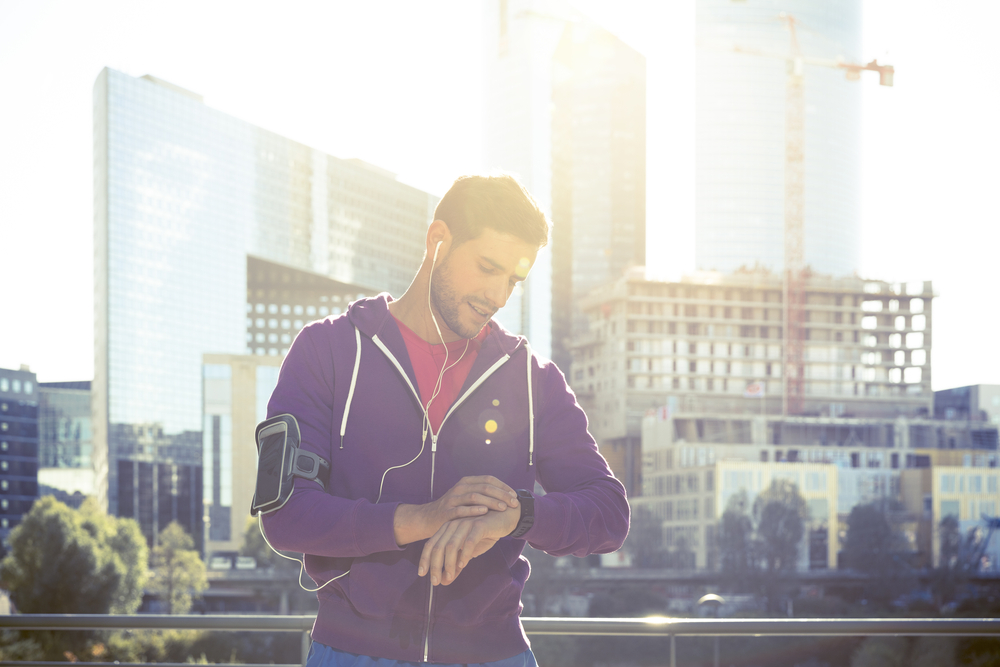 Athlete checking watch during a walk