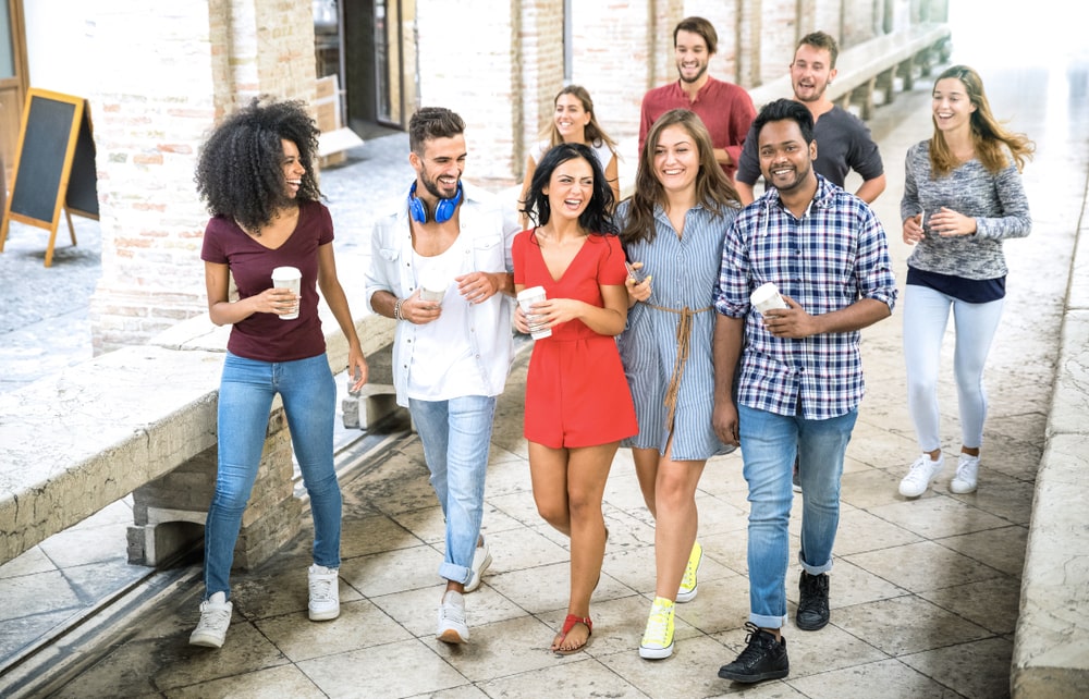 Multiracial group of people walking together in city