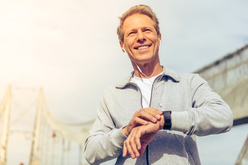 Fit middle-aged man checking smart watch