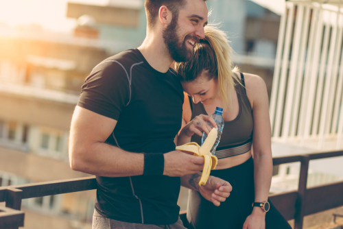 Couple eating a banana after a workout