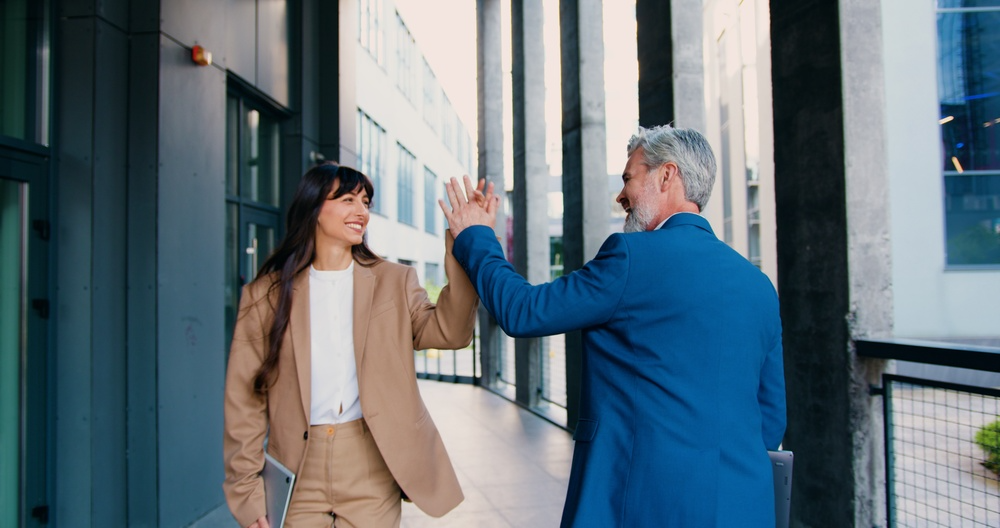 Coworkers walking together outside during a lunchtime workplace step challenge