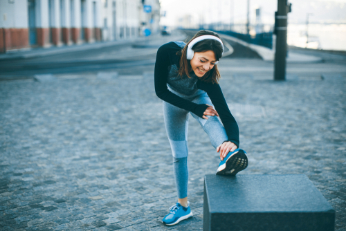Walker stretching while listening to headphones