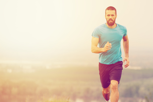 Sporty man walking for fitness in the countryside