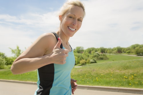 Female jogger giving thumbs up
