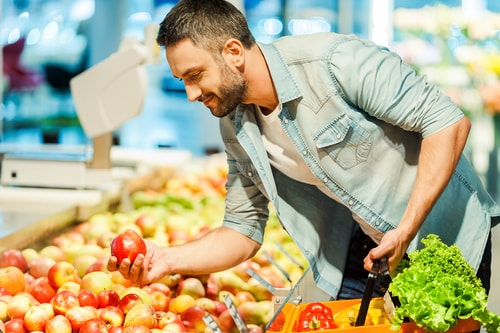 Man choosing an apple - health food concept