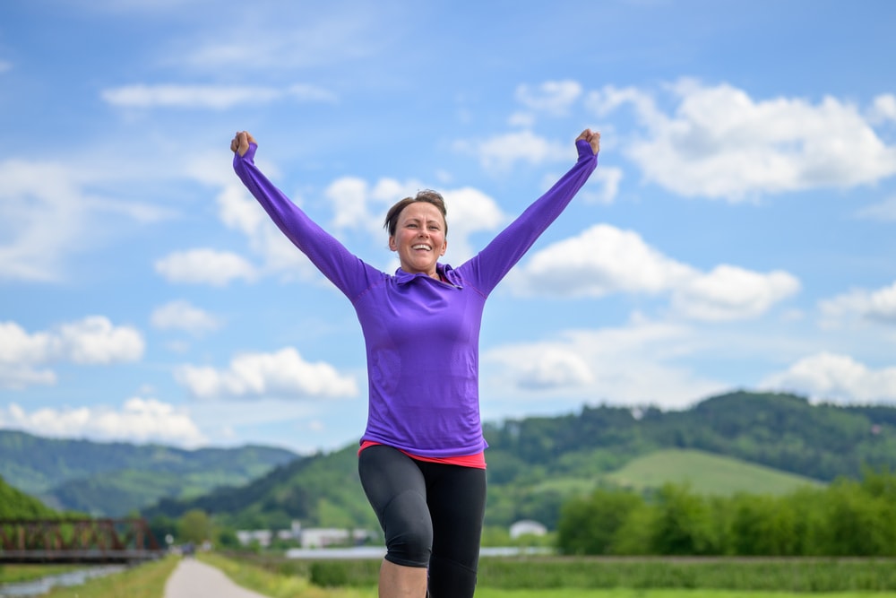 Woman celebrating achieving her fitness goals