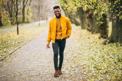 Man walking in the park in the autumn