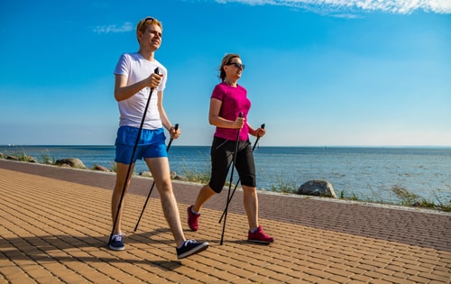 Couple doing Nordic walking by the seaside