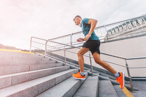 Man running up steps for fitness