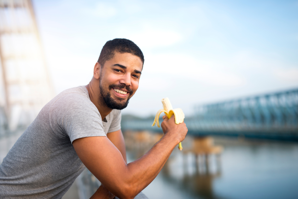 Man eating banana after a run or walk