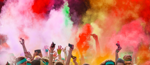 People throwing color powder in a color run